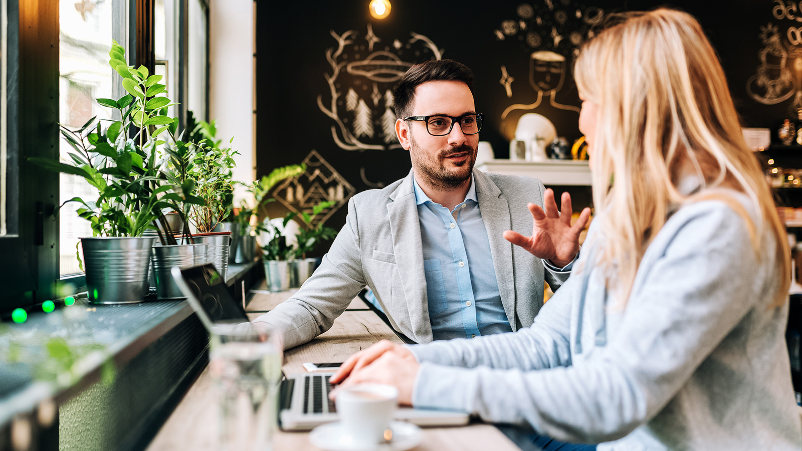 man-and-woman-talking-at-modern-working-space